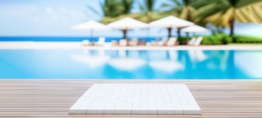 Empty ceramic mosaic table top and blurred swimming pool in tropical resort in summer banner background, for display or montage your products	