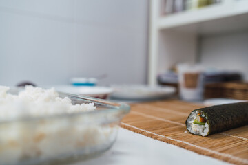 Diagonal image of a rolled nori seaweed sheet. Finished process of homemade sushi.