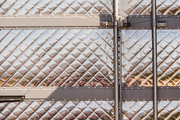 Close up, detail of the tractor trailer metal siding finish on the rear door.