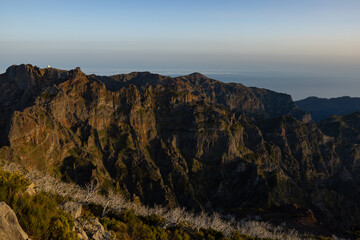 Amazing sunset on Pico Ruivo with a view of Pico do Arieiro during the golden hour, perfect for photography.