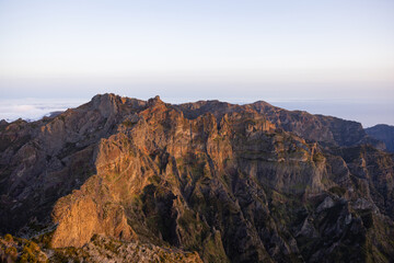 Great views of an epic colorful sunset over the mountain peaks of Madeira.