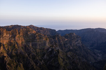 Fototapeta na wymiar Looking over from Pico Ruivo to Pico do Arieiro on a beautiful sunset in April 2022 after a strenuous hike to the summit.