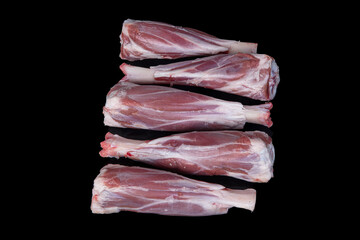 Fresh raw meat of lamb leg. Raw lamb leg isolated on black background. ossobuco (lamb shank steak with bones).