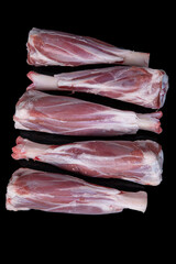 Fresh raw meat of lamb leg. Raw lamb leg isolated on black background. ossobuco (lamb shank steak...