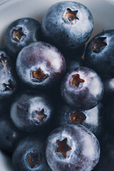 Close up of organic blueberries in a white bowl