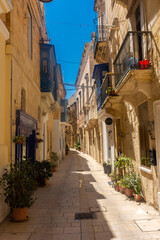 Fototapeta na wymiar Birgu, Malta, 22 May 2022: Street in the old town of Birgu, one of the Three Cities