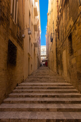 Fototapeta na wymiar Valletta, Malta, 22 May 2022: Stairs of a street in Valletta old town