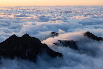 Epic sea of ​​clouds on a wonderful evening over Pico Ruivo in Madeira.