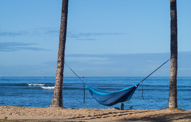 Tropical View of a Blue Hammock on a Deserted Beach.