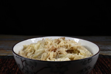 Traditional boiled and steamed organic Chinese cabbage mixed with tofu sheet serving in the bowl. Famous vegetarian food with high fiber and vitamin.
