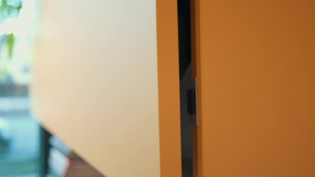 orange hanging cabinet door closes automatically in the kitchen