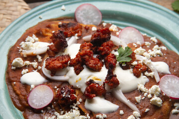 Mexican enfrijoladas with chorizo and fresh cheese