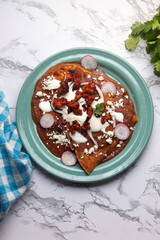 Mexican enfrijoladas with chorizo and fresh cheese