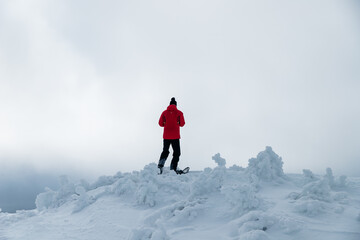 person on top of a mountain covered by snow