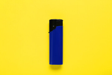Stylish small pocket lighter on yellow background, top view
