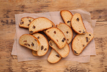 Sweet hard chuck crackers with raisins on wooden table, flat lay