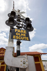 Railroad signal. written in portuguese: railway crossing stop look listen