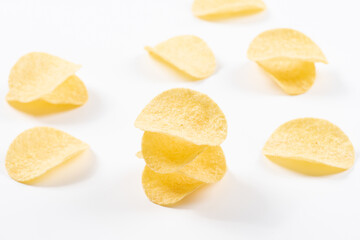 Fototapeta na wymiar Pile of potato chips on white background.