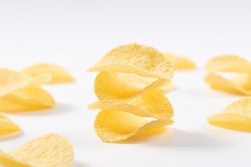 Pile of potato chips on white background.