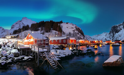 Fabulous evening  seascape of Norwegian sea and cityscape of Nusfjord village with Northern Lights