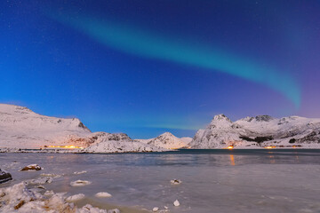 Fabulous frozen Flakstadpollen and Boosen fjords with Northern Lights at night.