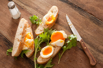 Tasty breakfast of boiled egg on baguette