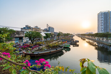 HOCHIMINH CITY, VIETNAM - JANUARY 29, 2022: Evening at Flower market on Tet holiday "Tren Ben Duoi Thuyen" every year at Binh Dong Wharf, District 8. People carry flowers from the West on boats.