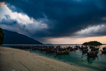 Fototapeta na wymiar Sunrise beach with long tail boats in Koh Lipe, Satun, Thailand