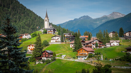 Fototapeta na wymiar Typical Swiss village in a valley of the Swiss Alps in Switzerland - travel photography