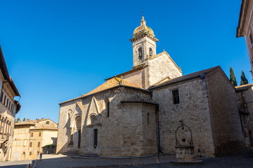Fototapeta na wymiar San Quirico d'Orcia, Italy, 16 April 2022: Medieval church of the historic center