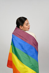 Pretty woman LGBQ pose with muli-color flag