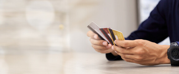 Businessman holding credit card for online bill shopping, positive man shopping online remote payment , smart payment concept individual bank