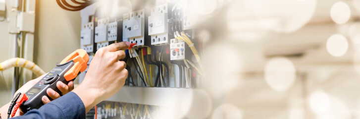 Electrician engineer work  tester measuring  voltage and current of power electric line in...