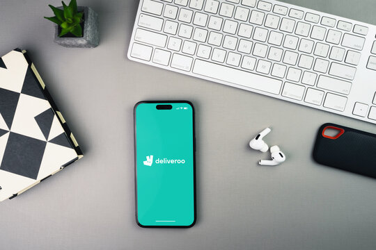 Deliveroo delivery app on the smartphone screen on grey background table. Office environment. Rio de Janeiro, RJ, Brazil. January 2023