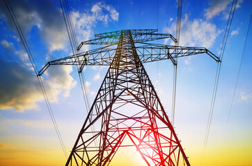 Electric pylon. Transmission tower with sunset sky at the background.