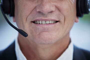 Closeup, call center and man with headphones, customer support and help in office. Agent, senior...