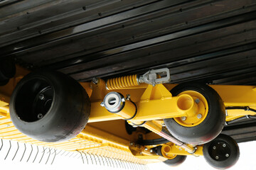 Black wheels fixed on the yellow frame.