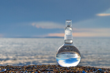 Glass flask by the sea.