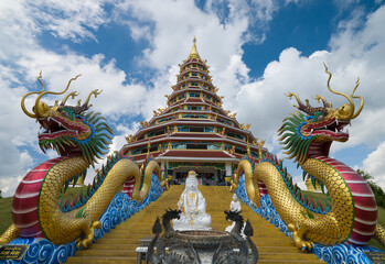Fototapeta premium Wat Rong Seur Ten or Blue temple. Modern Buddhist temple distinguished by its vivid blue and yellow coloring elaborate carvings. Northern Thailand
