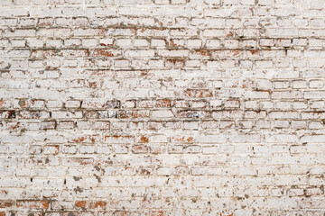 Texture of an old brick wall painted in white, background