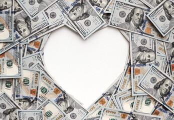 Dollar bills in the shape of heart. The love of money. Valentine's day concept. Heart shape sign...