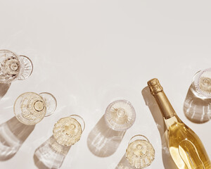 Top view white sparkling wine in different glasses of wine, stemmed glass with sun shadow and glare...
