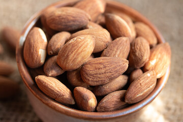 Roasted almonds in a ceramic cup.Warm tone image.