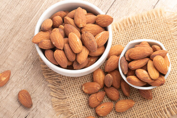 Salted almonds in a white cup.Copy space.