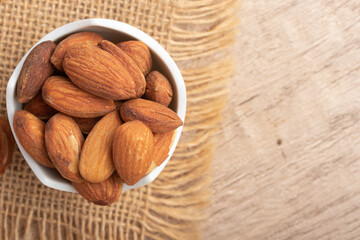 Salted almonds in a white cup.Copy space.