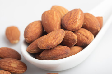 Salted almonds in a white cup.Copy space.