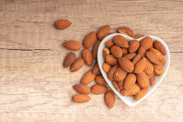 Salted almonds in a white cup.Copy space.