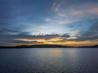 Obraz premium After the rain sunrise waterscape with clouds