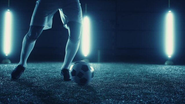 skilled football player practicing dribbling exercises, closeup view of legs and ball, slow motion