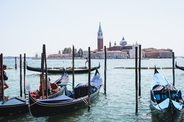 Fototapeta na wymiar Venice, Italy: San Giorgio Maggiore church and gondolas at sunny day in Venice, Italy.
